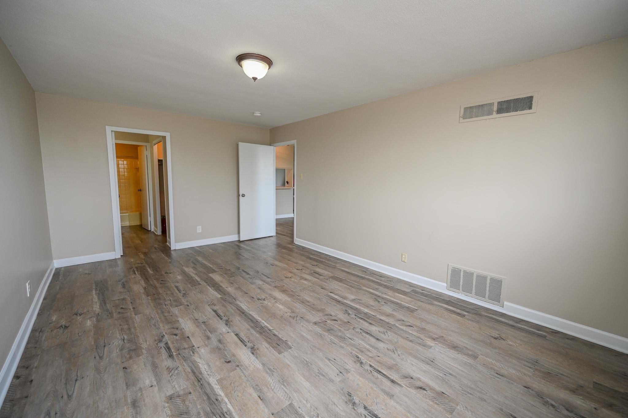 2277 Union Avenue, Unit 408 Memphis, TN 38104 - Photo 9 of 31 a view of an empty room and wooden floor