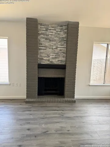 a view of fireplace and wooden floor