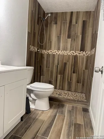 a bathroom with a toilet and a shower