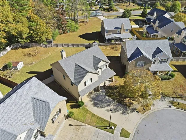 an aerial view of a house with a yard
