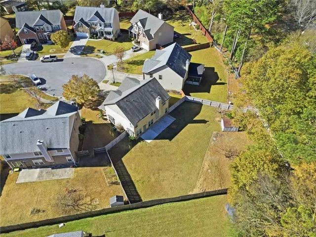 an aerial view of residential houses with outdoor space