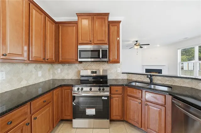 a kitchen with stainless steel appliances granite countertop a refrigerator and cabinets