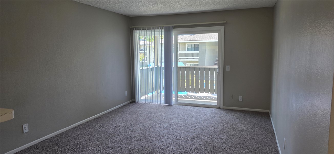 10601 Diana Avenue, Unit 408 Riverside, CA 92505 - Photo 4 of 10 an empty room with windows