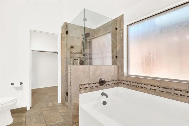 a bathroom with a double vanity sink mirror and toilet