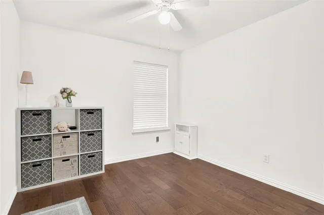 a view of a workspace with furniture and a book shelf