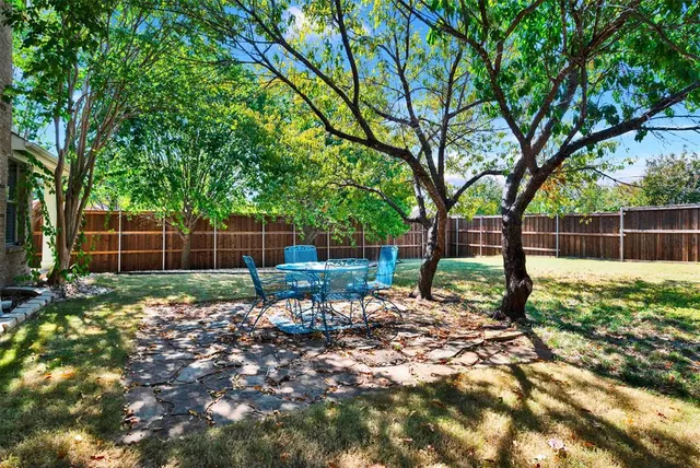 a view of a porch with chairs and backyard