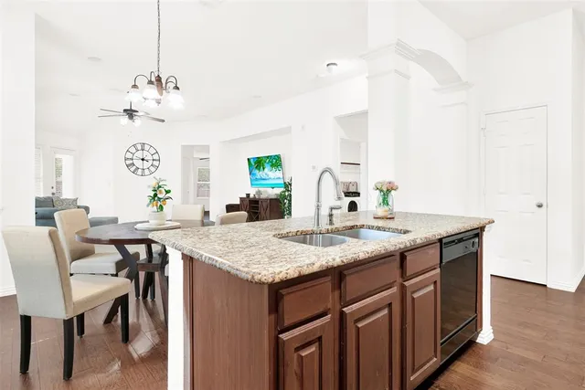 a kitchen with granite countertop a refrigerator stove and oven