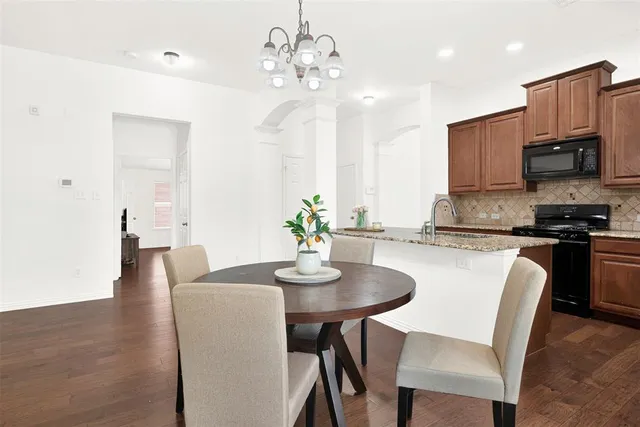 a view of a kitchen area with furniture and a chandelier