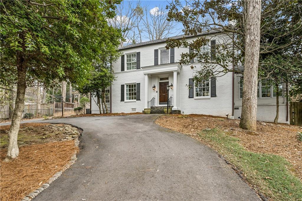 3905 Peachtree Dunwoody Road Atlanta, GA 30342 - Photo 1 of 1 a front view of a house with a yard