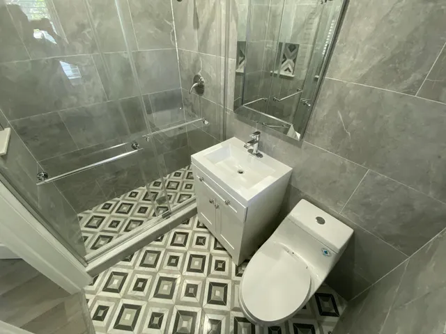 a bathroom with a sink toilet and shower