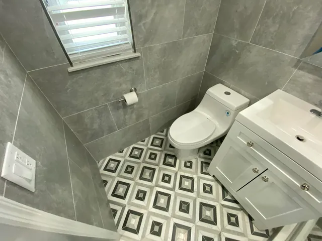a bathroom with a toilet and a shower