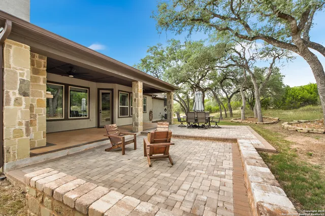 a view of a house with backyard and sitting area