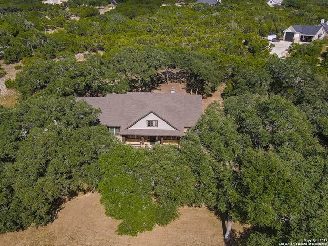 an aerial view of a house with a yard