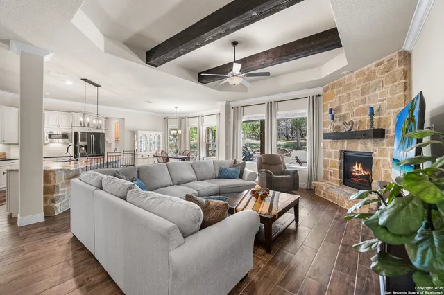 a living room with furniture a fireplace a potted plant and a fireplace