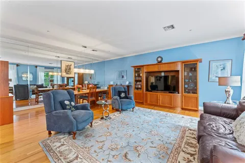 a living room with furniture window and wooden floor