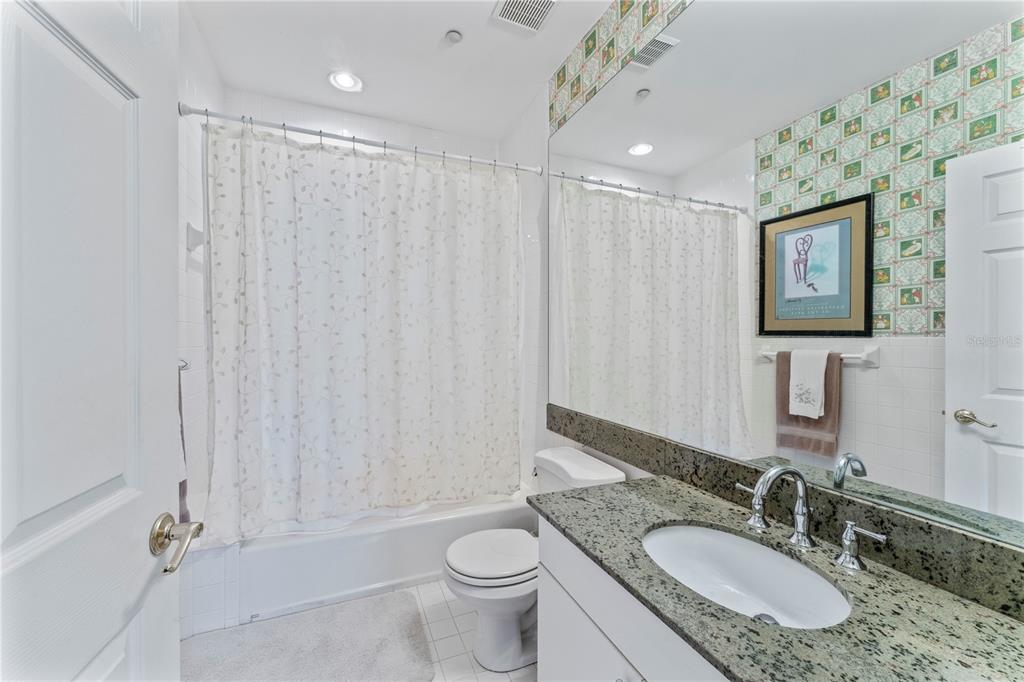 3011 West Mason Street, Unit B Tampa, FL 33629 - Photo 29 of 42 a bathroom with a granite countertop sink toilet and shower