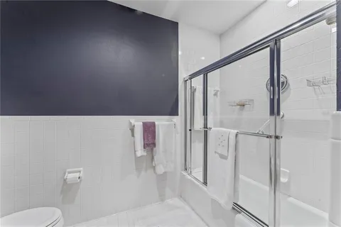 a bathroom with a toilet and a shower