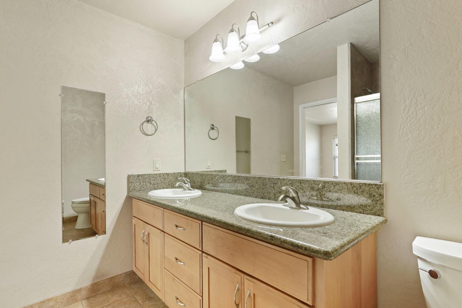 2636 West Turner Road Lodi, CA 95242 - Photo 13 of 24 a bathroom with a sink double vanity and a mirror