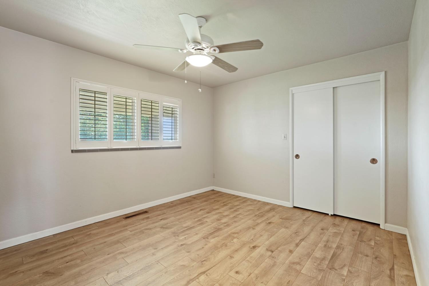 2636 West Turner Road Lodi, CA 95242 - Photo 15 of 24 a view of an empty room with wooden floor and a window