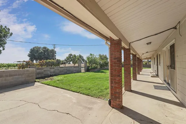 a view of a patio with a yard