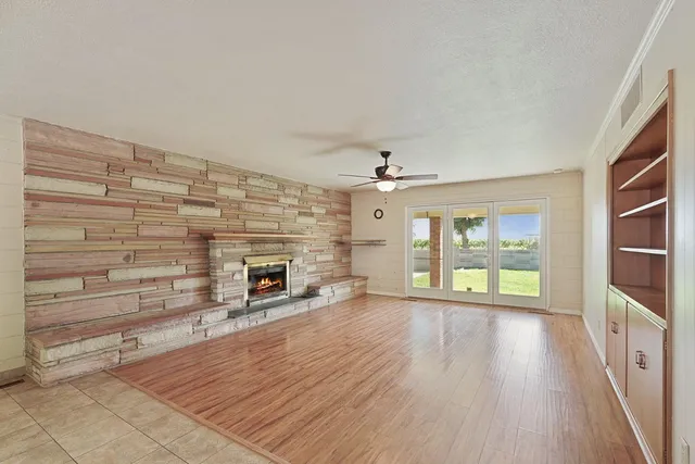 wooden floor in an empty room with a fireplace