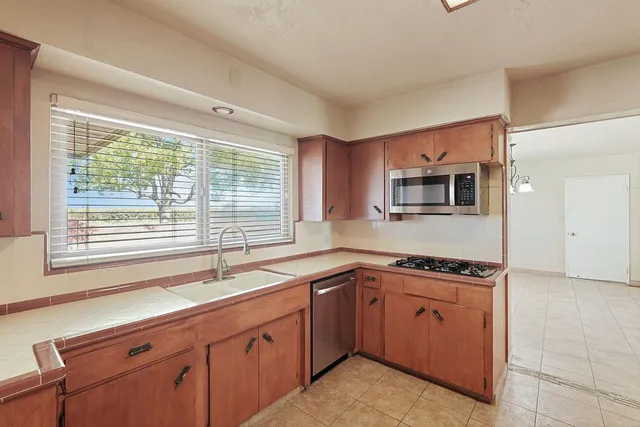 a kitchen with a sink cabinets and window