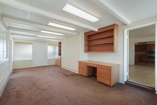 an empty room with furniture and natural light