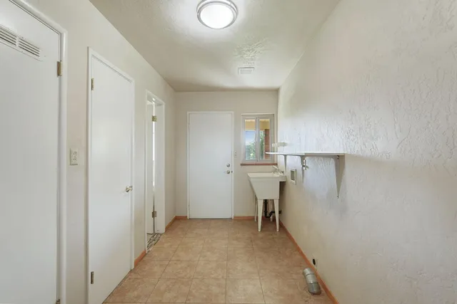 a view of a kitchen from a hallway