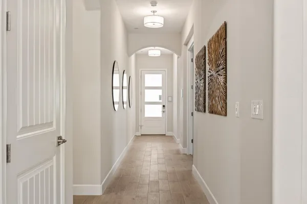 a living room with furniture a flat screen tv and a floor to ceiling window