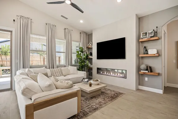 a view of a house with backyard and sitting area