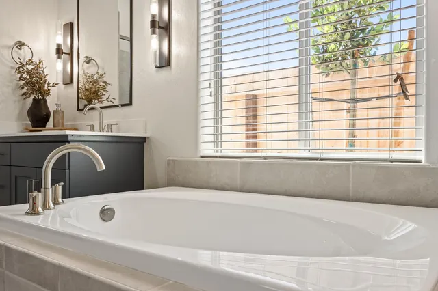 a bathroom with a bathtub and a sink
