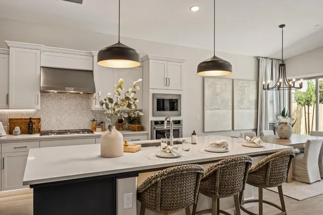 a stove top oven sitting inside of a kitchen
