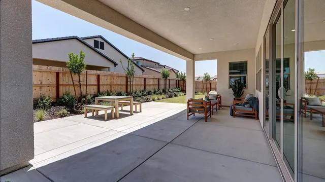 a view of a house with backyard and sitting area