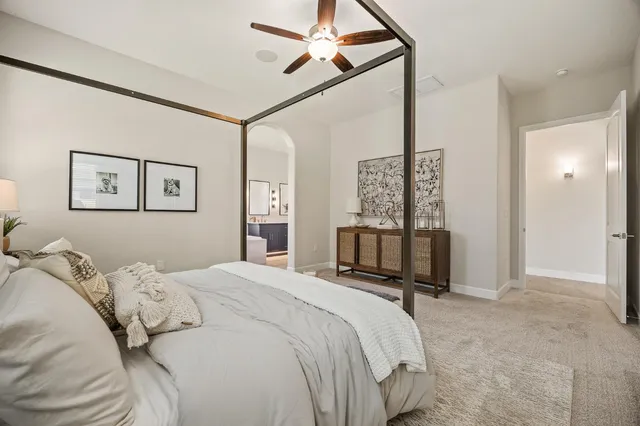 a bedroom with a bed mirror and window