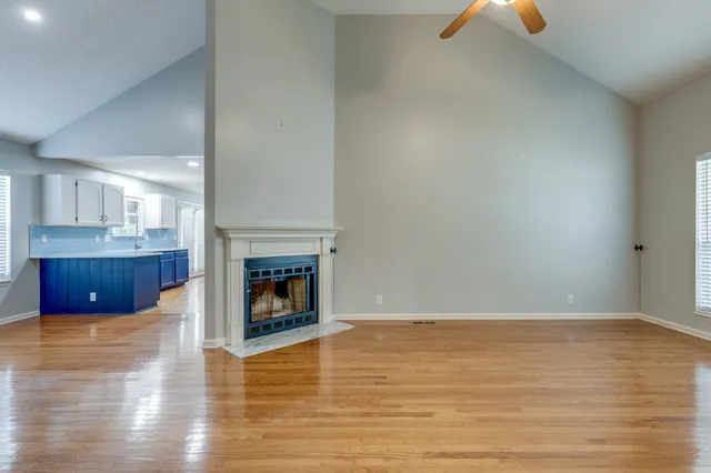 a view of a room wooden floor and fire place