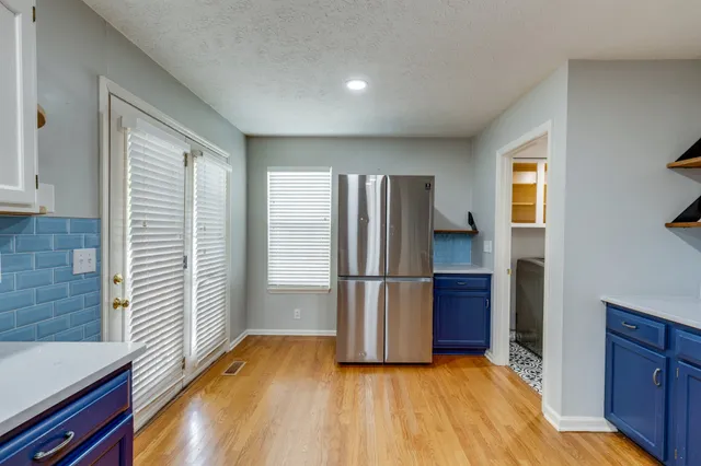 a view of kitchen with furniture and refrigerator
