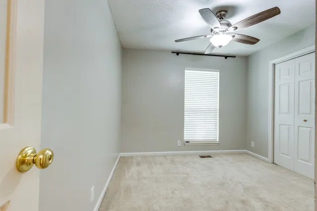 a view of a chandelier fan and windows