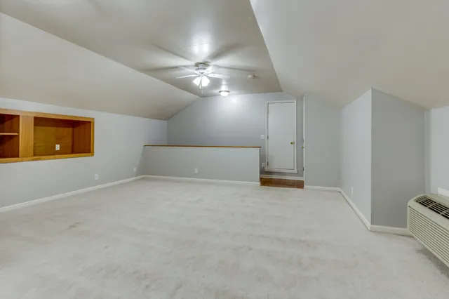 a view of a lake with a bench and trees