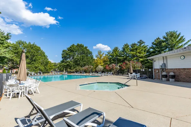 a swimming pool with outdoor seating and yard