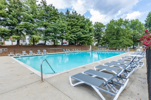 a view of yard with large trees and playing ground