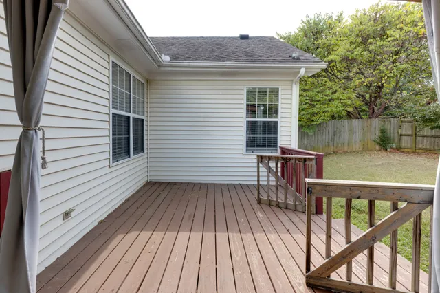 a view of a wooden deck with a yard