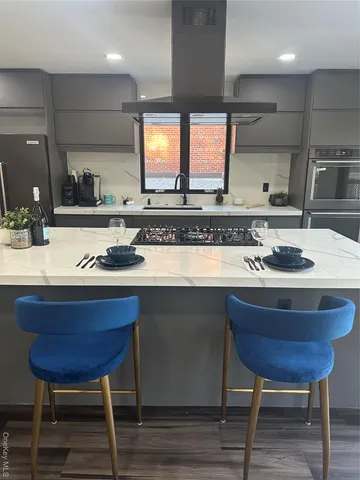 a kitchen with stainless steel appliances granite countertop a sink and a stove