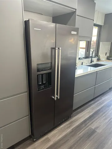 a kitchen with a table chairs sink and cabinets
