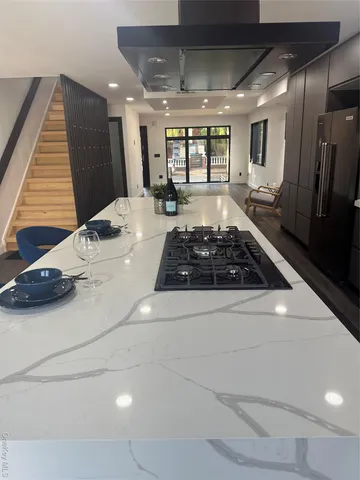 a view of empty room with window and wooden floor