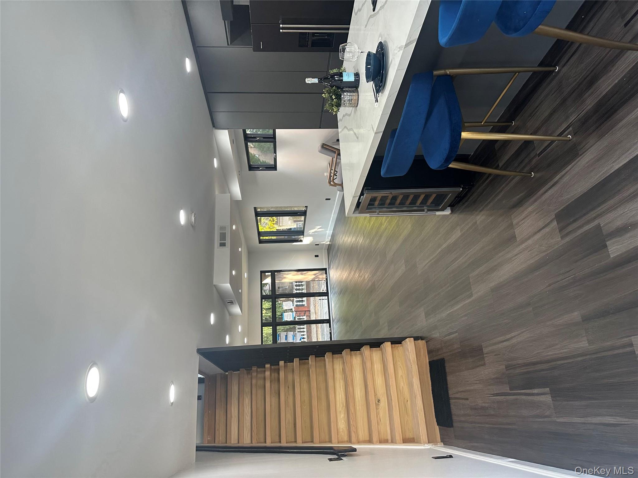 5918 Delafield Avenue Bronx, NY 10471 - Photo 14 of 31 a kitchen with a table chairs sink and cabinets