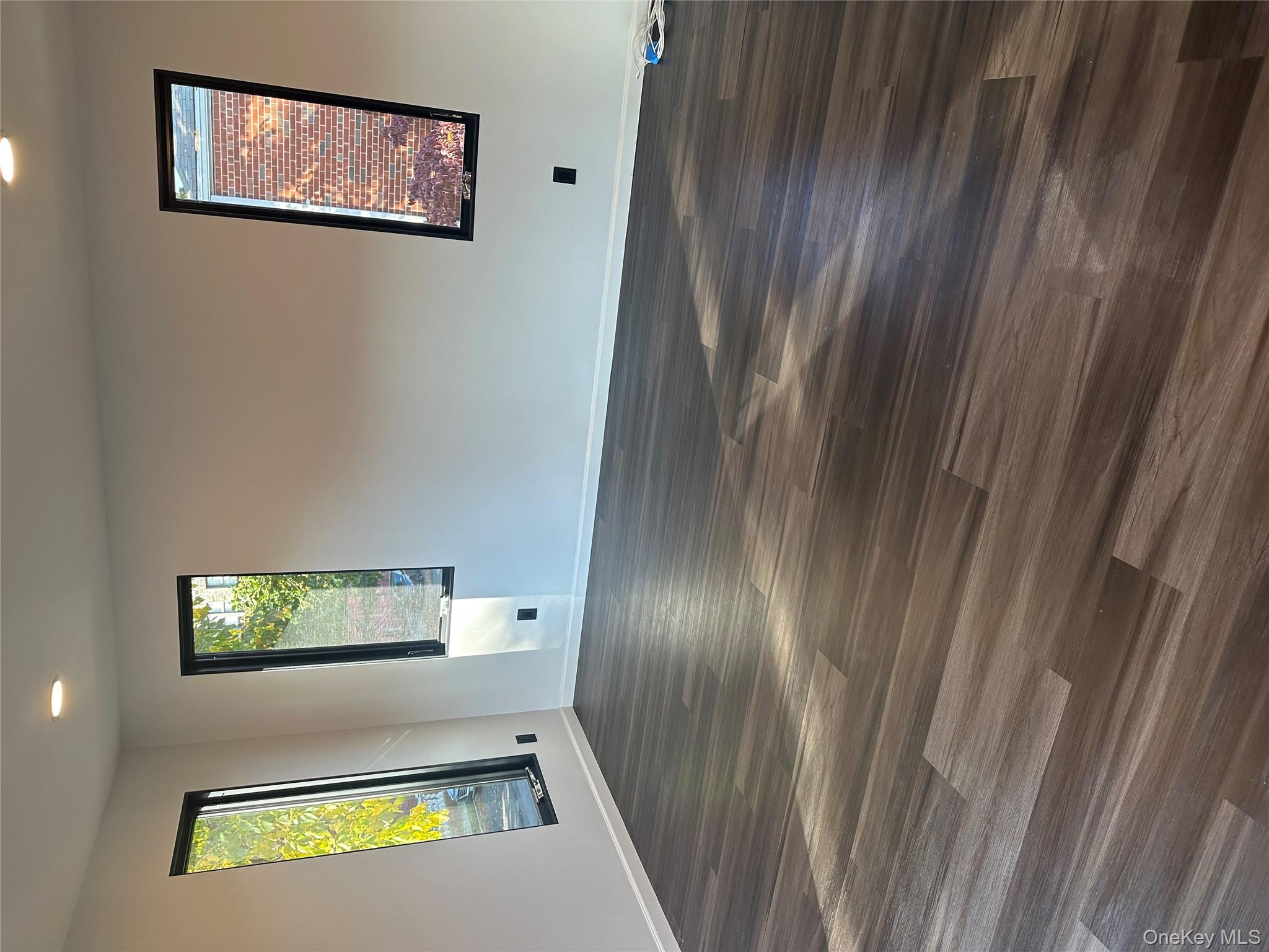 5918 Delafield Avenue Bronx, NY 10471 - Photo 15 of 31 a view of empty room with window and wooden floor