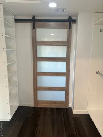 a bathroom with a toilet and a mirror