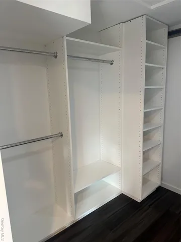 a spacious bedroom with a balcony a bed and a window