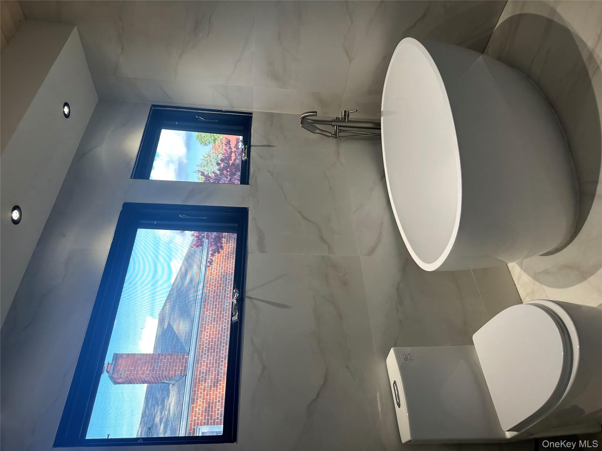 5918 Delafield Avenue Bronx, NY 10471 - Photo 19 of 31 a bathroom with a toilet and a mirror