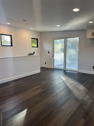 a view of a wooden floor and a yard from a balcony